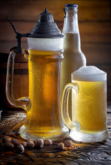 Light beer in a glass on a table in composition with accessories on an old background