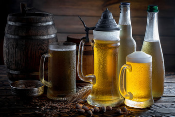 Light beer in a glass on a table in composition with accessories on an old background