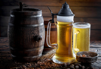 Light beer in a glass on a table in composition with accessories on an old background