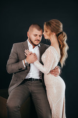 Stock Photo - Portrait of beautiful young wedding couple at black background