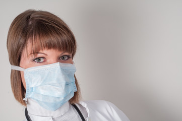 Close up of female doctor with protection mask isolated on white 