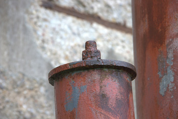 View of an eroded pipe with steel cover and screw connection