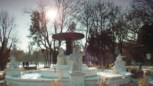 Slow motion close up of a frozen artesian fountain in winter