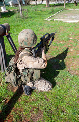 kneeling soldier aiming with the rifle