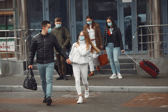 Travelers leaving airport are wearing protective masks.