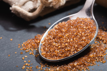 Metal spoon with ground brown sugar