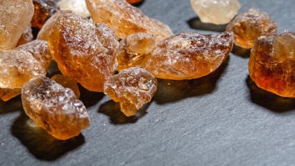 Nuggets of brown sugar on slate plate
