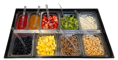 Kiwi fruit, strawberry, blueberry, mango garnishes for frozen yogurt or yoghurt in toppings or garnishes tray