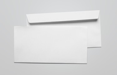 Blank card and white envelope on the desk - obrazy, fototapety, plakaty