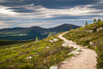 Hiking trail near Aviemore in Scottish Highlands with Cairngorms peaks on the horizon. Scenic...