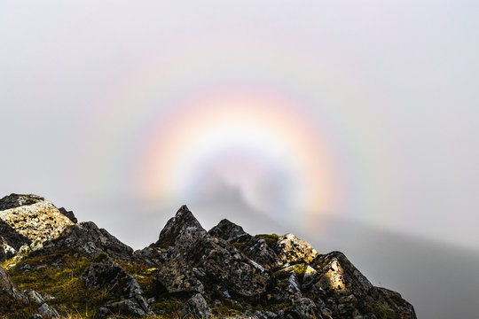 Glory rainbow, natural phenomenon, on a mountain top in dense fog in Glen Coe, Scotland.
