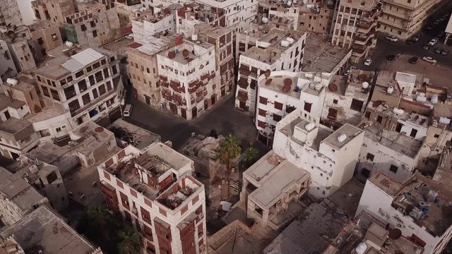 Tilting drone footage of beautiful architecture of old (both neglected and renovated) houses in Al Balad district in Jeddah, Saudi Arabia