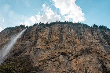Small mountain waterfall. Summer alpine mountain landscape