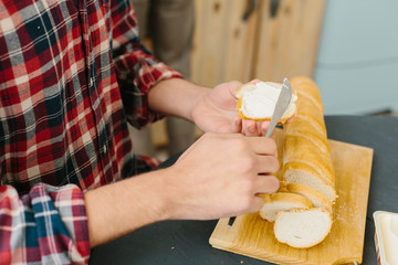 young man making sandwiches