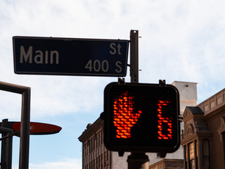 Cross processed Main st. sign and traffic lights with buildings in the background, Los Angeles, United States. Stop sign.