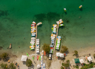 Top view of the lake shore with clear water with a bridge and pleasure boats and catamarans. Aerial photography