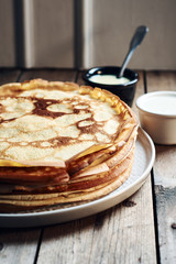 Thin pancakes, crepes with condensed milk.