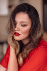 Portrait of beautiful young woman with makeup in fashion red clothes