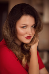 Portrait of beautiful young woman with makeup in fashion red clothes