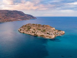 Aerial photo of Spinalonga island in blue sea waters off the coast of Crete in Greece