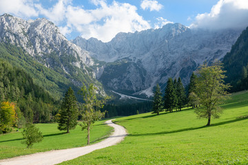 Scenic view of the idyllic countryside underneath a spectacular rocky ridge.