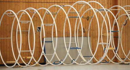 gymnastic apparatus called "Rhoenrad" (German Wheel) in a row inside of a gym