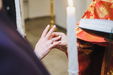 Religious marriage in the Orthodox church. Wedding matrimony. Exchanging wedding rings. Priest...