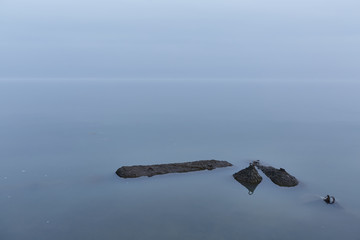 Blue sea merges with the sky in absolute calmness in early morning