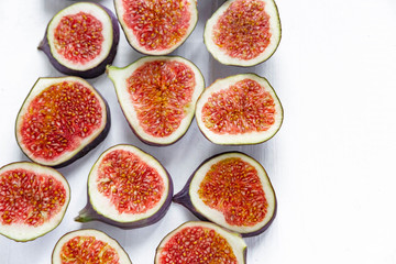 Sliced figs on a light background. Healthy fruits. Nutrition with diet, vegetarianism, healthy nutrition. Flat lay, top view.