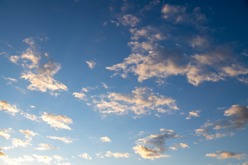 Sunset cloud on a moody vivd blue sky. Stormy and windy weather cumulus cloud at springtime.