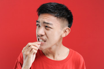 Young Asian man using a toothpick to clean his tooth. Healthy life young Asian man