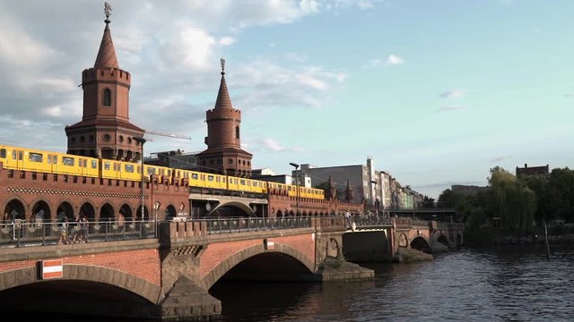 Berlin Oberbaum bridge connecting Friedrichshain and Kreuzberg - yellow train close up