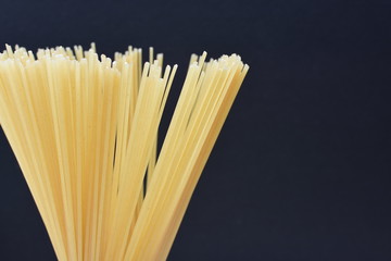 Italian long pasta, on dark background