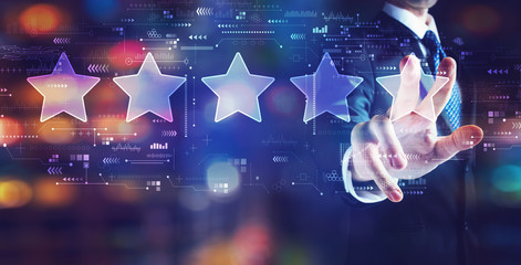Rating star concept with businessman on night city background