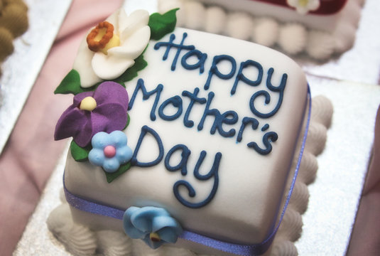 Happy Mother's Day cake with white icing and marzipan flowers