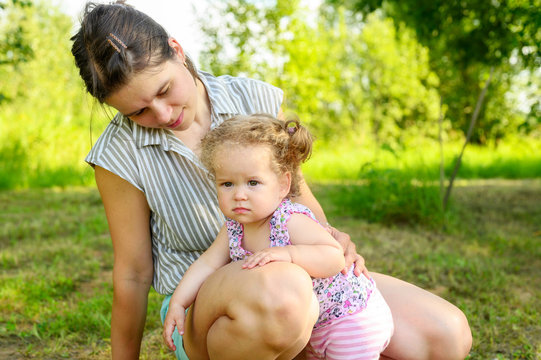 Mom Plays With Her Cute Little One Year Old Daughter With Curly Hair. Family With Little Children Have Fun Spending Summer Holidays In Nature Outdoor