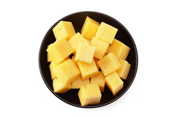 Cut of cheese in a black plate isolated on a white background. top view