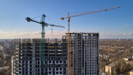 Fototapeta premium Construction of high-rise residential building. Aerial view of construction of high-rise apartment building.