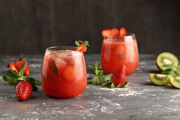 Cold, strawberry lemonade with mint, ice cubes and kiwi, a delicious drink to quench your thirst in...