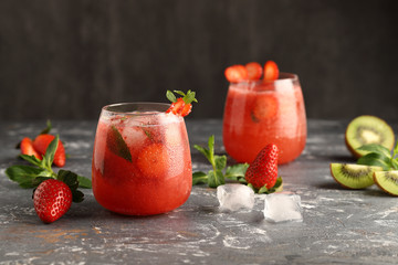 Cold, strawberry lemonade with mint, ice cubes and kiwi, a delicious drink to quench your thirst in the hot summer.