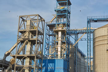 Fototapeta na wymiar Port grain elevator. Industrial sea trading port bulk cargo zone grain terminal