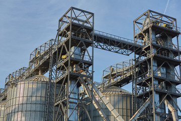 Port grain elevator. Industrial sea trading port bulk cargo zone Railway wagon in grain terminal