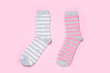 Two pairs of Women's socks on a colored background