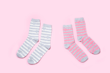 Two pairs of Women's socks on a colored background