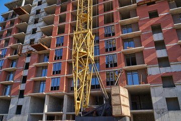 Fototapeta premium Construction site. High rise Building under construction. Construction of high-rise residential building