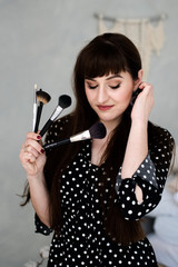 Makeup artist in overalls with polka dots