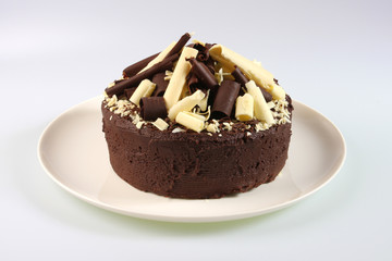 A chocolate sponge cake with a dark and white chocolate topping