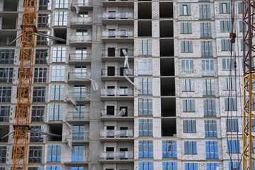 Fototapeta na wymiar Construction site. High rise Building under construction. Construction of high-rise residential building
