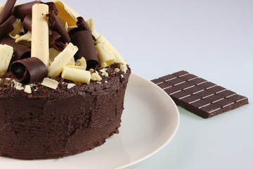 A chocolate sponge cake with a dark and white chocolate topping