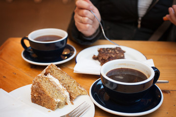 Coffee and cake in a cafe in front of friends